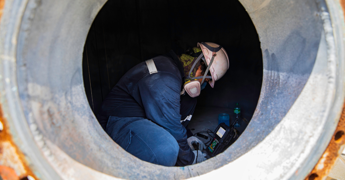 Worker conducting gas monitoring inside a confined space for the Confined Spaces & Gas Test Atmospheres to represent the Full Course at Down Under Training.