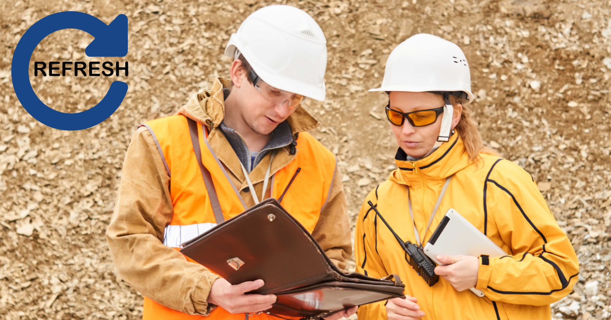 Two supervisors in safety gear reviewing a risk management process in the field, representing the G2 Risk Facilitator Refresher Course.