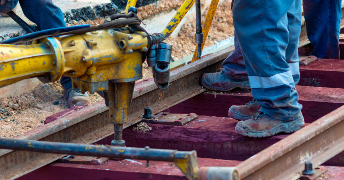 Workers using equipment to maintain a rail track in the rail corridor.