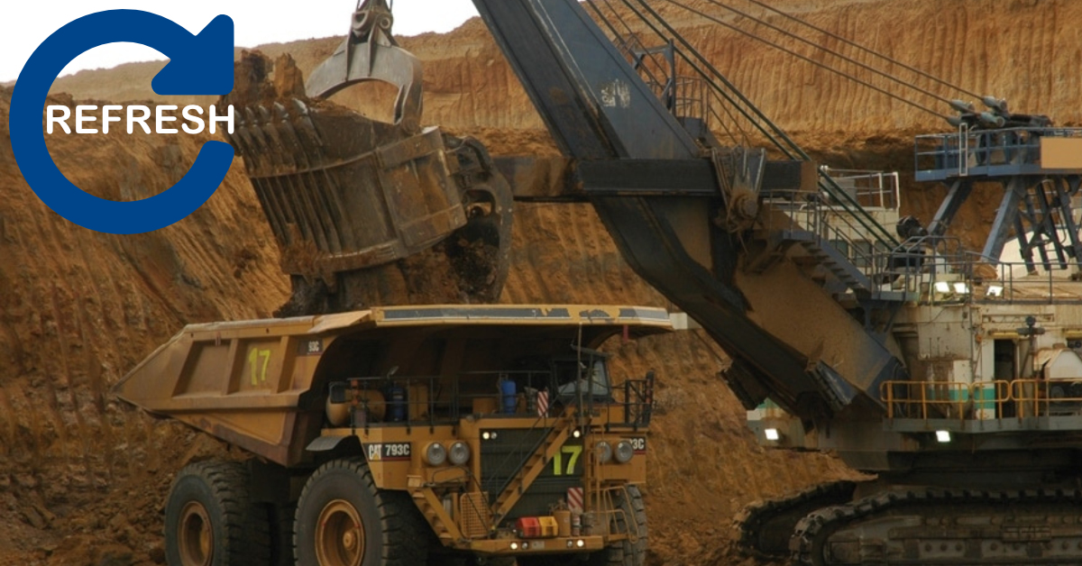 Excavator loading dirt into a mining truck at a coal mine site, representing mining environments covered in the Standard 11 Combined Induction _REFRESHER